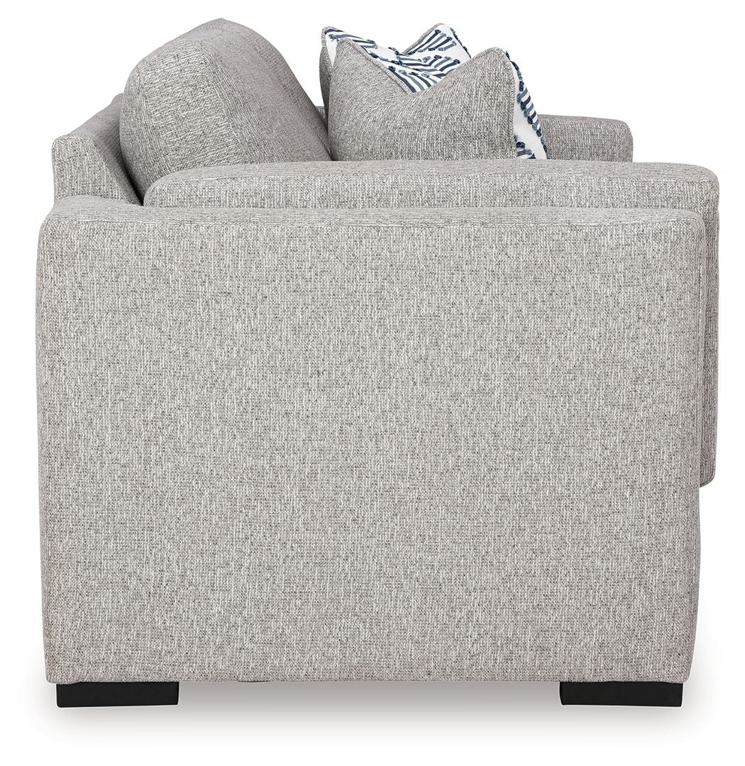 Light gray loveseat sofa with rounded arms and white-and-blue striped throw pillows