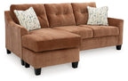Clay sofa chaise with chaise extension, two patterned pillows, and block feet