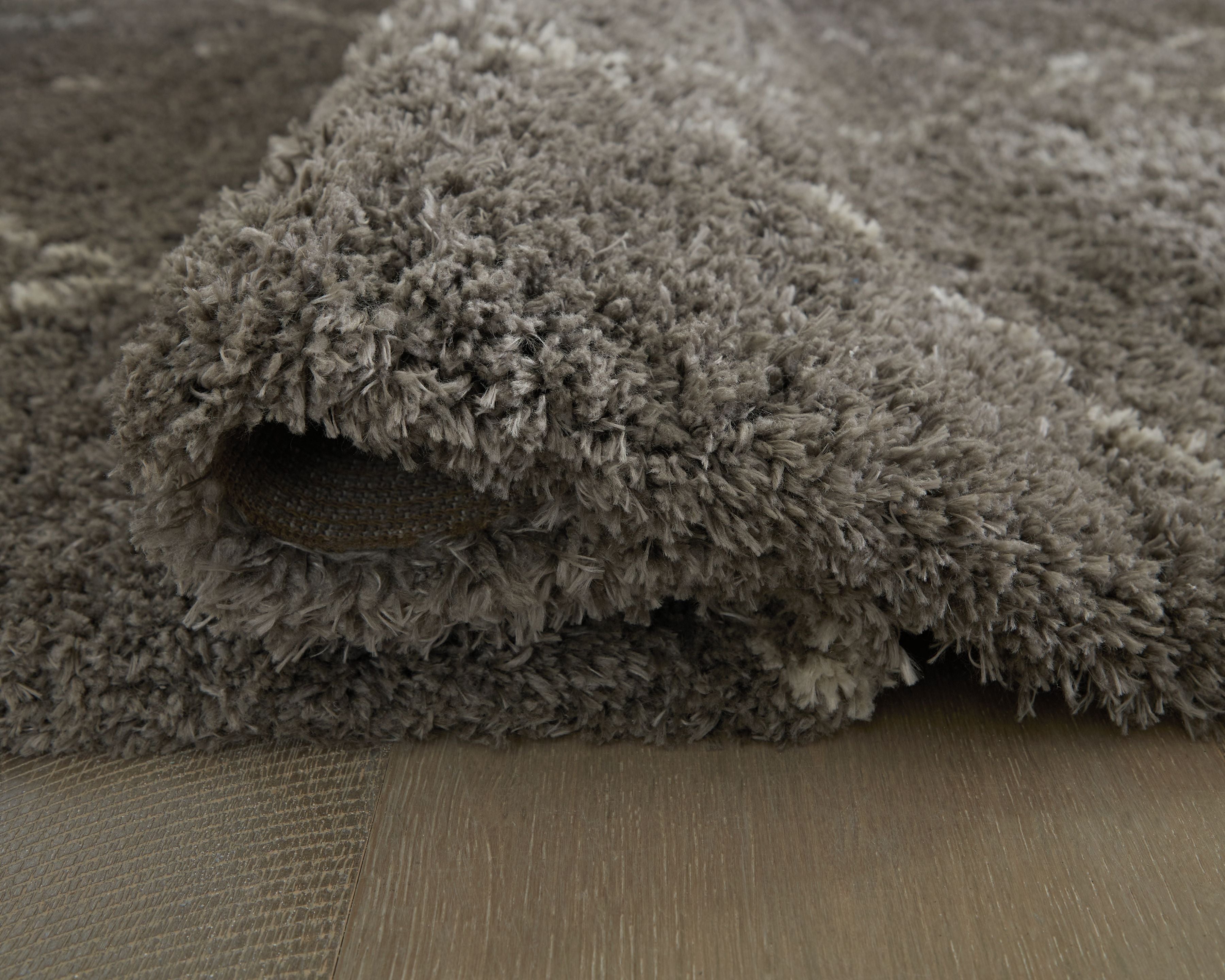 Dark gray shag area rug with thick pile and visible rug edge