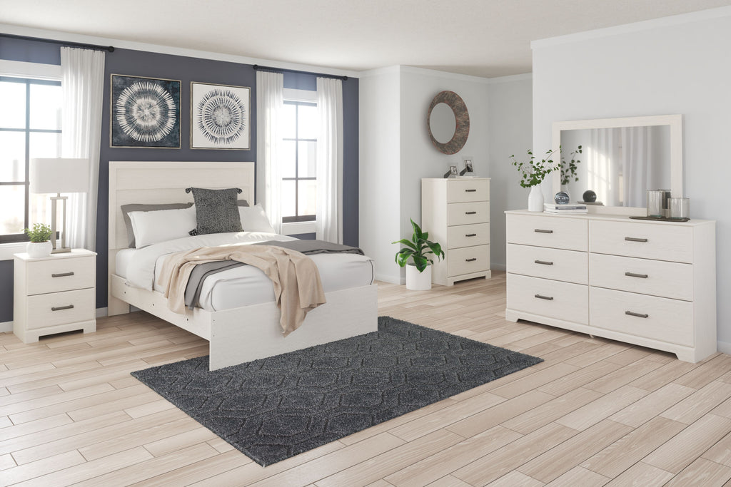 White panel bedroom set with bed, dresser, and mirror