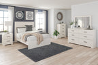 White panel bedroom set with bed, dresser, and mirror