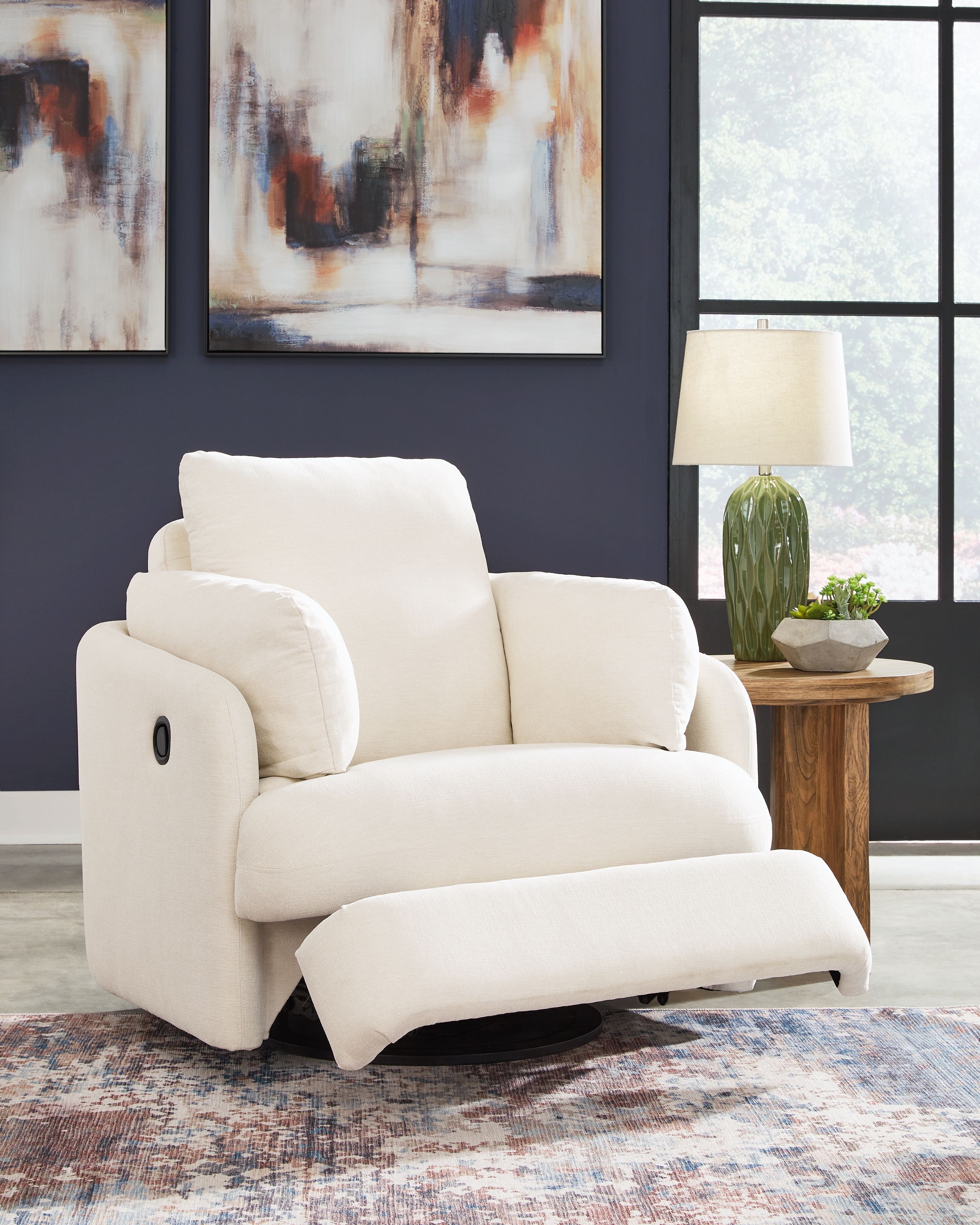 Swivel glider recliner chair in white fabric, padded arms and supportive backrest.