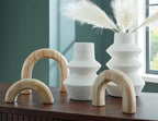 Sculptural decor set with white textured vases and two natural wood arch supports