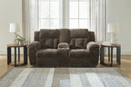 Dark brown double reclining loveseat with rounded arms and tufted back cushions