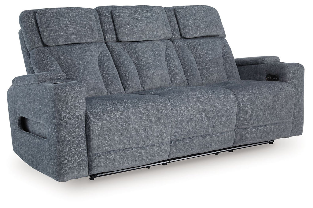 Steel gray power reclining sofa with padded armrests and three seat sections