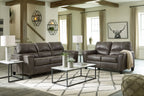 Dark gray sofa and loveseat with padded arms and tufted back cushions
