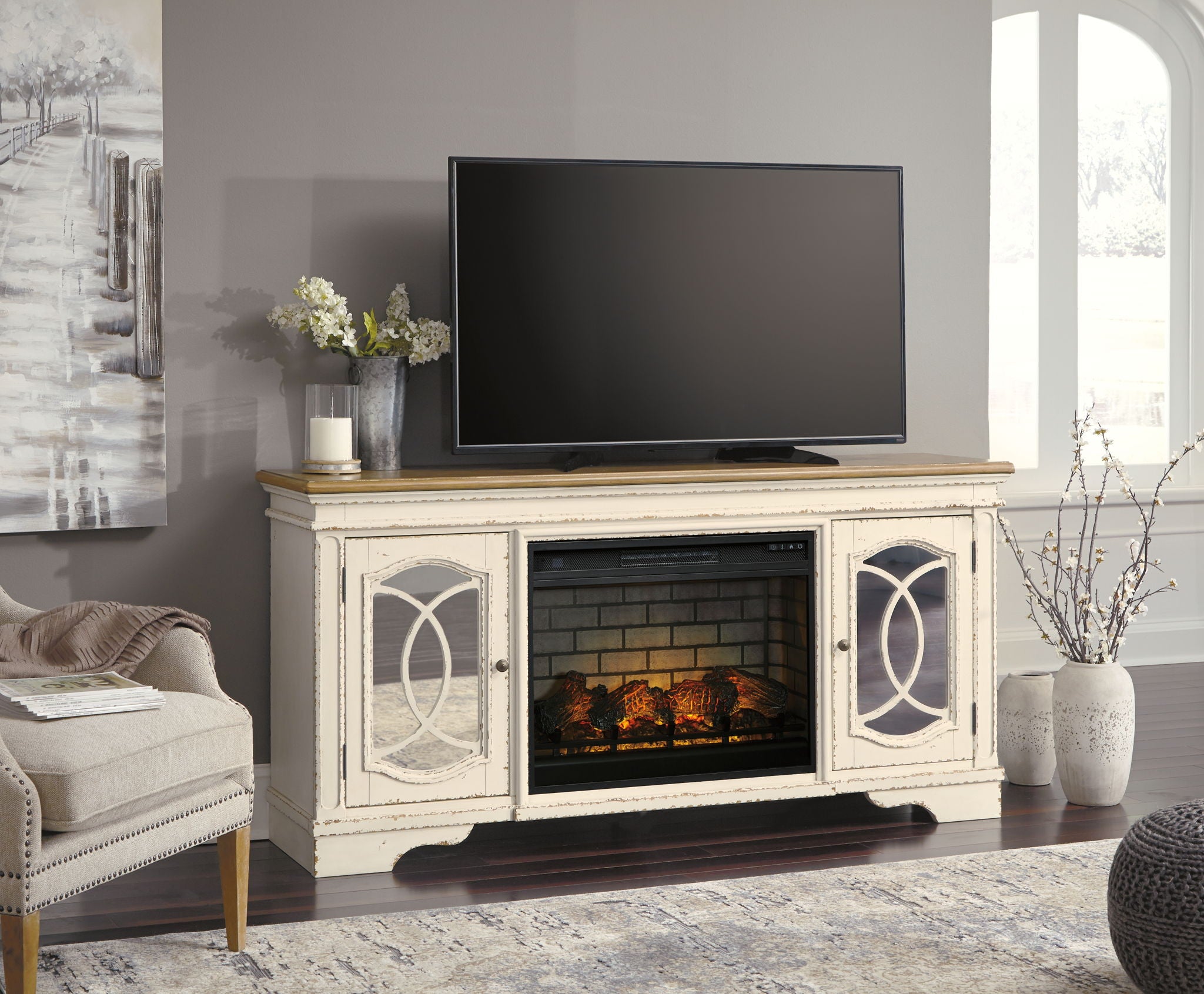Chipped white TV stand with electric fireplace insert and flat-screen TV above