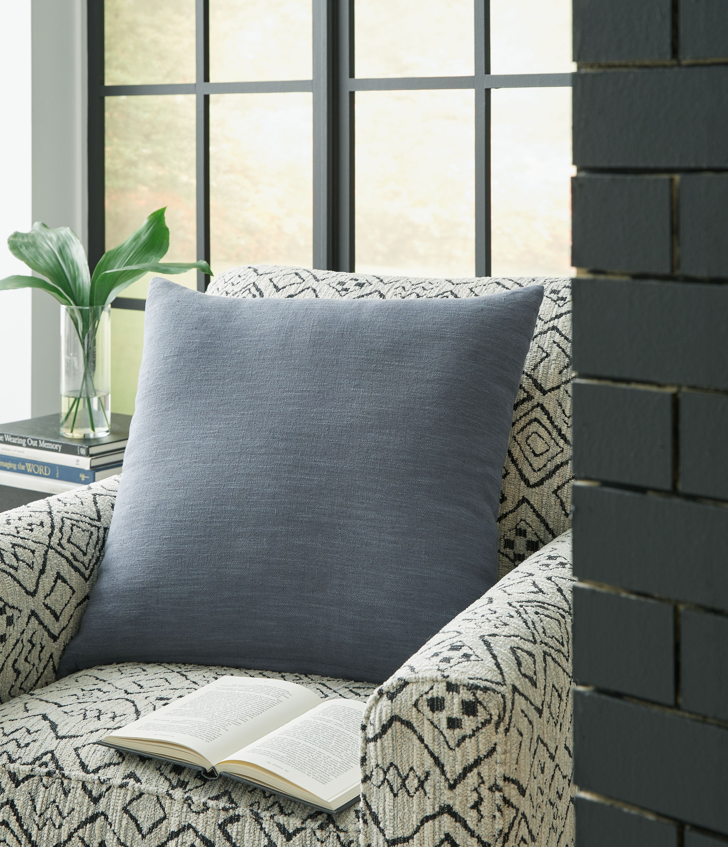 Light blue square throw pillow with plain woven fabric and stitched edges