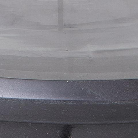 Dark base surface with textured finish for a glass cylinder candle holder