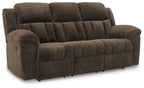 Chocolate brown reclining sofa with tufted back, padded arms, and cushioned seat