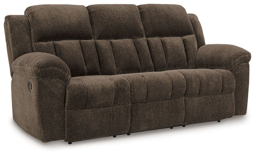 Chocolate brown reclining sofa with tufted back, padded arms, and cushioned seat