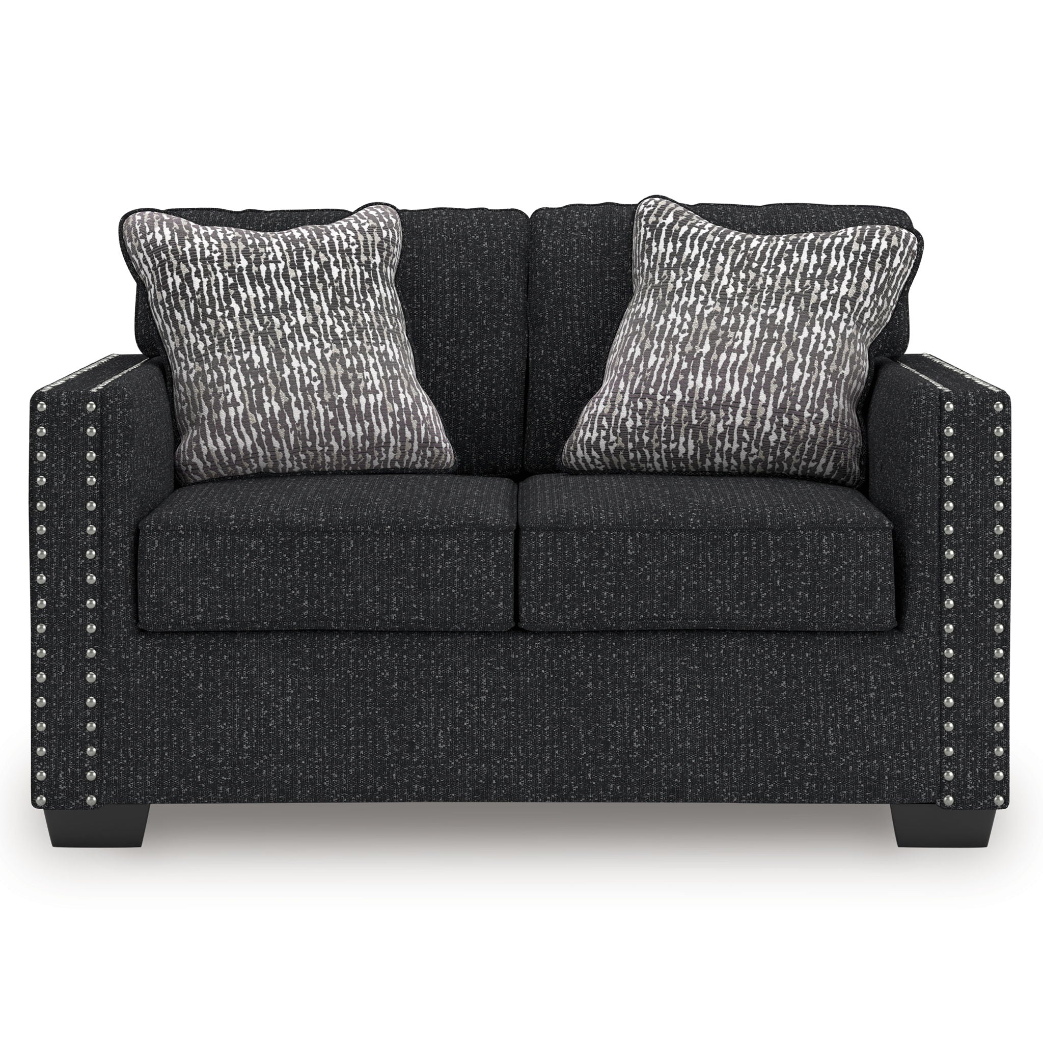 Charcoal loveseat with two patterned throw pillows and studded nailhead side accents