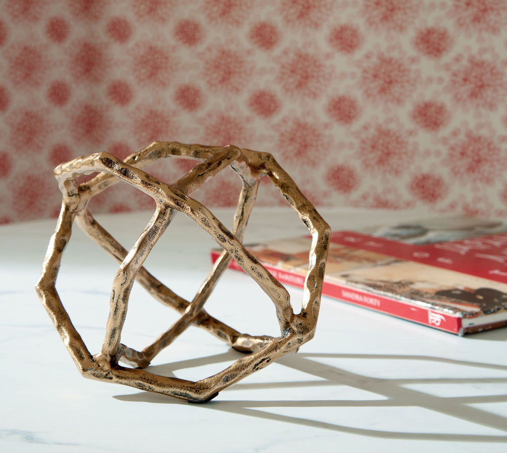 Laddington sculpture: light brown open frame with crisscross bars, angled view.