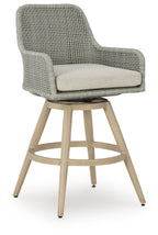 Bar stool with beige cushion, light gray woven back, and wood legs