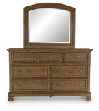 Medium brown dresser with arched mirror and multiple drawers