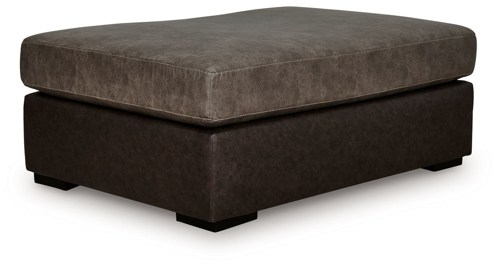 Oversized accent ottoman with square padded top, dark brown fabric, low wooden feet.