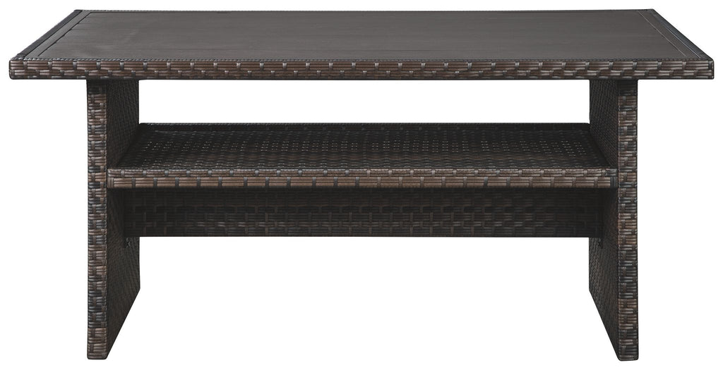 Dark brown multi-use table with beige woven accents, shelf and open base