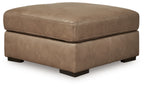 Taupe oversized ottoman with square top, padded sides, black legs