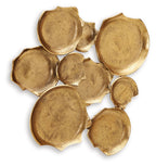 Antique gold wall decor of embossed metal leaf plaques, curved discs, scattered