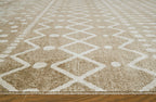 Close-up tan and cream rug pile with diamond and zigzag motif, textured surface