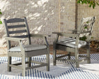 Gray slat-back outdoor chairs with padded seats beside a dining table