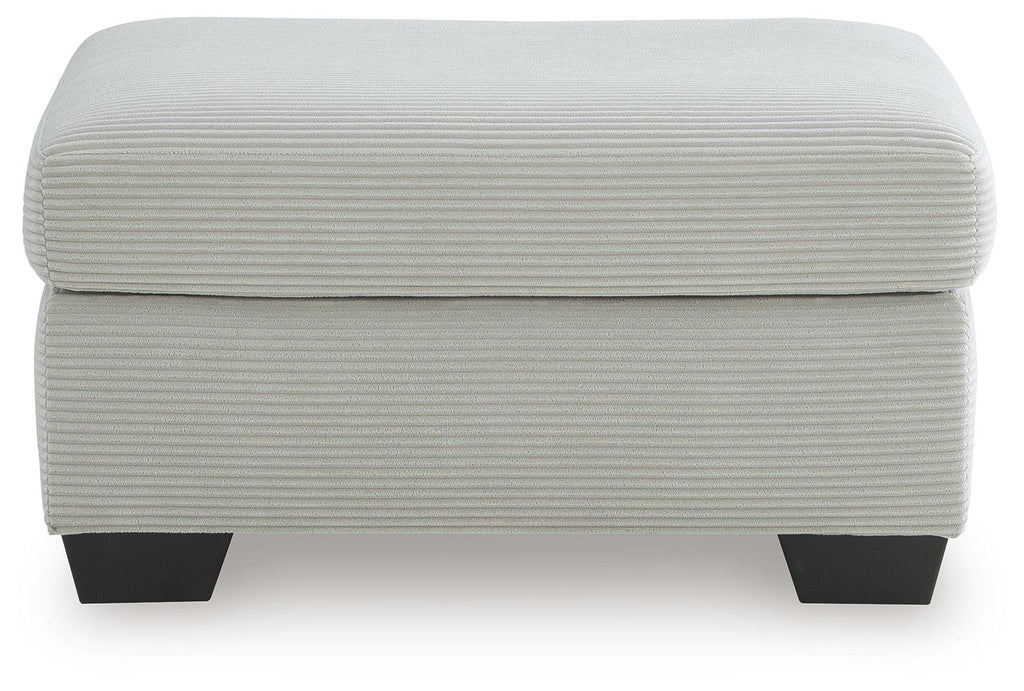 Light gray upholstered ottoman with padded lid and dark square legs