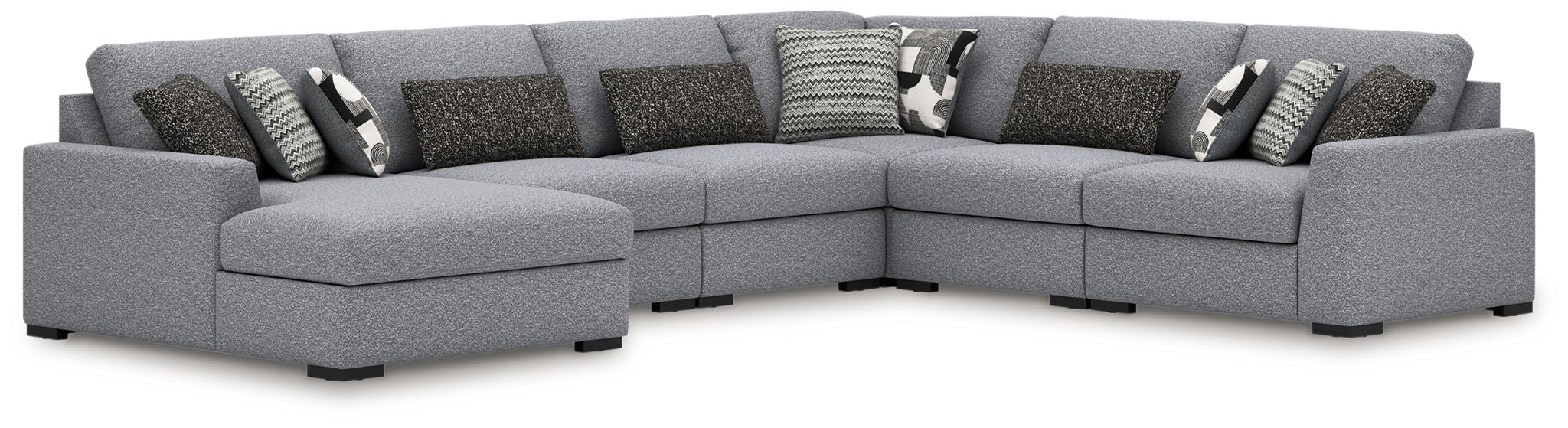 Gray fabric sectional sofa with corner chaise and multiple patterned throw pillows