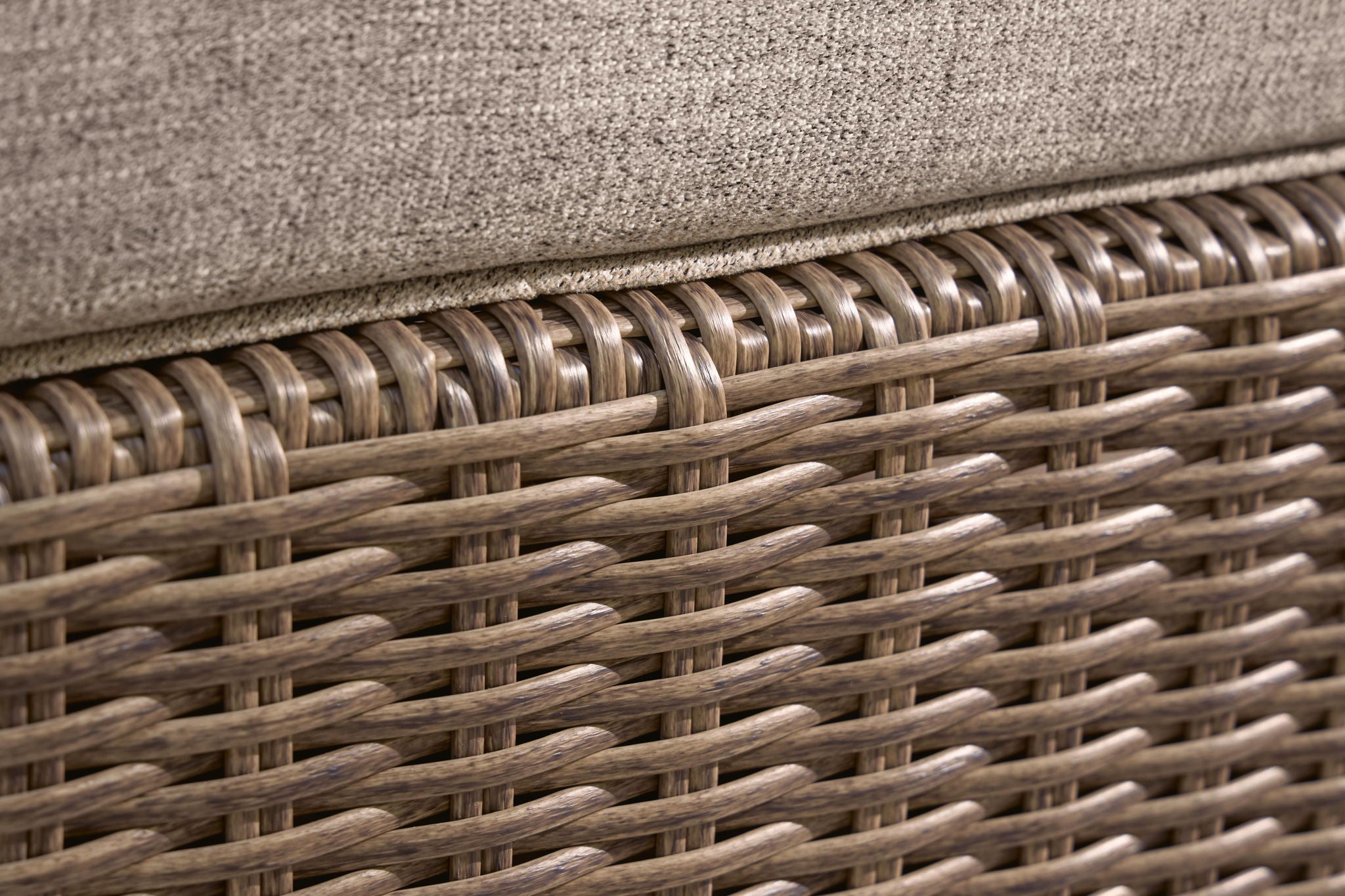 Outdoor sectional woven wicker frame detail, brown and tan strands