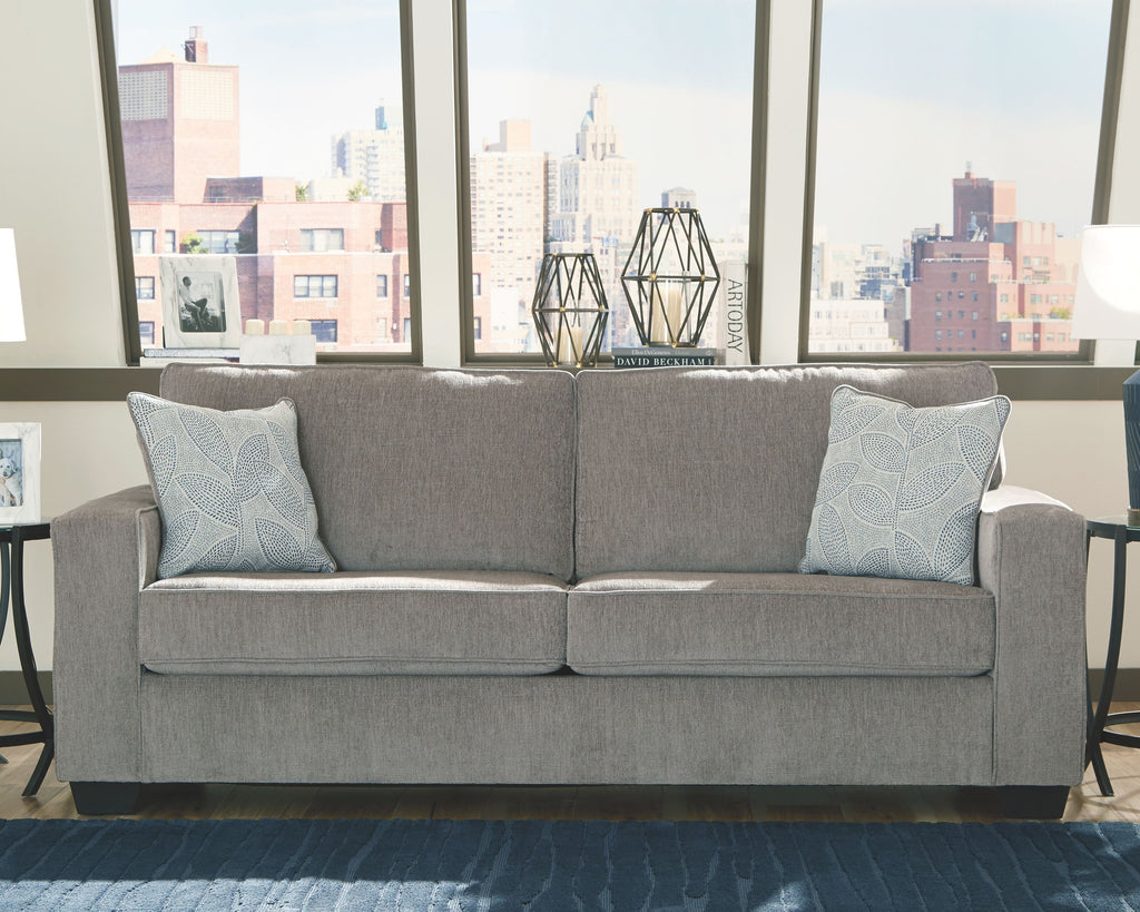 Alloy stationary sofa with three back cushions and two light patterned throw pillows