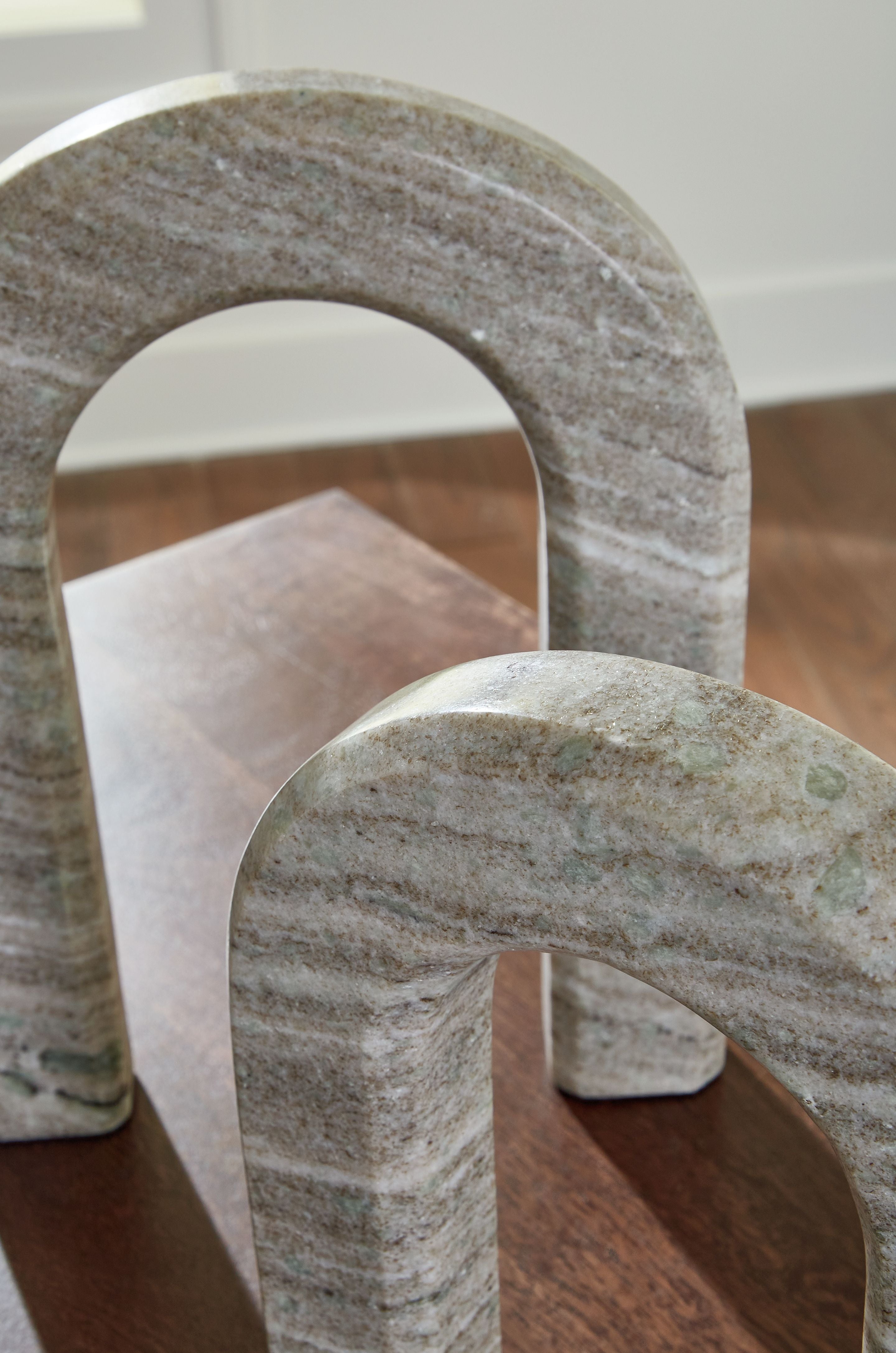 Taupe stone arch decor set of 2 on wood surface, one angled view