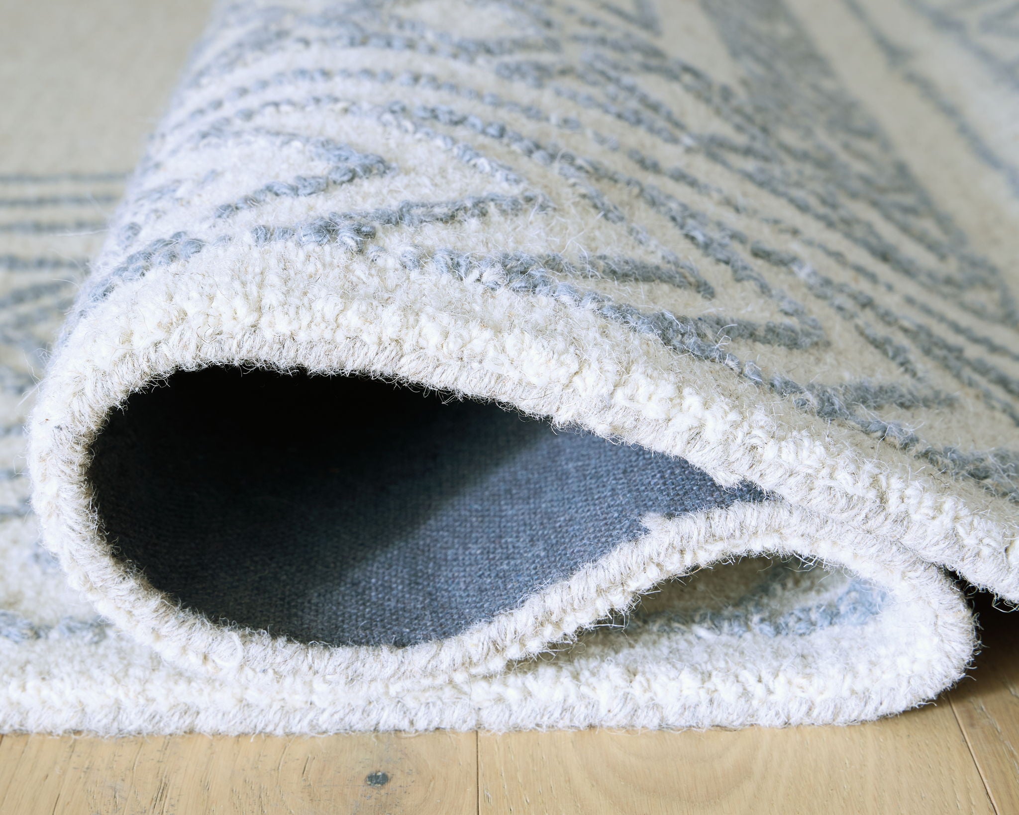 Geometric rug edge with bound border and visible backing