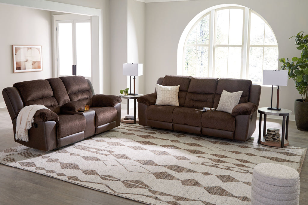 Geometric area rug with ivory base and dark brown diamond pattern in living room