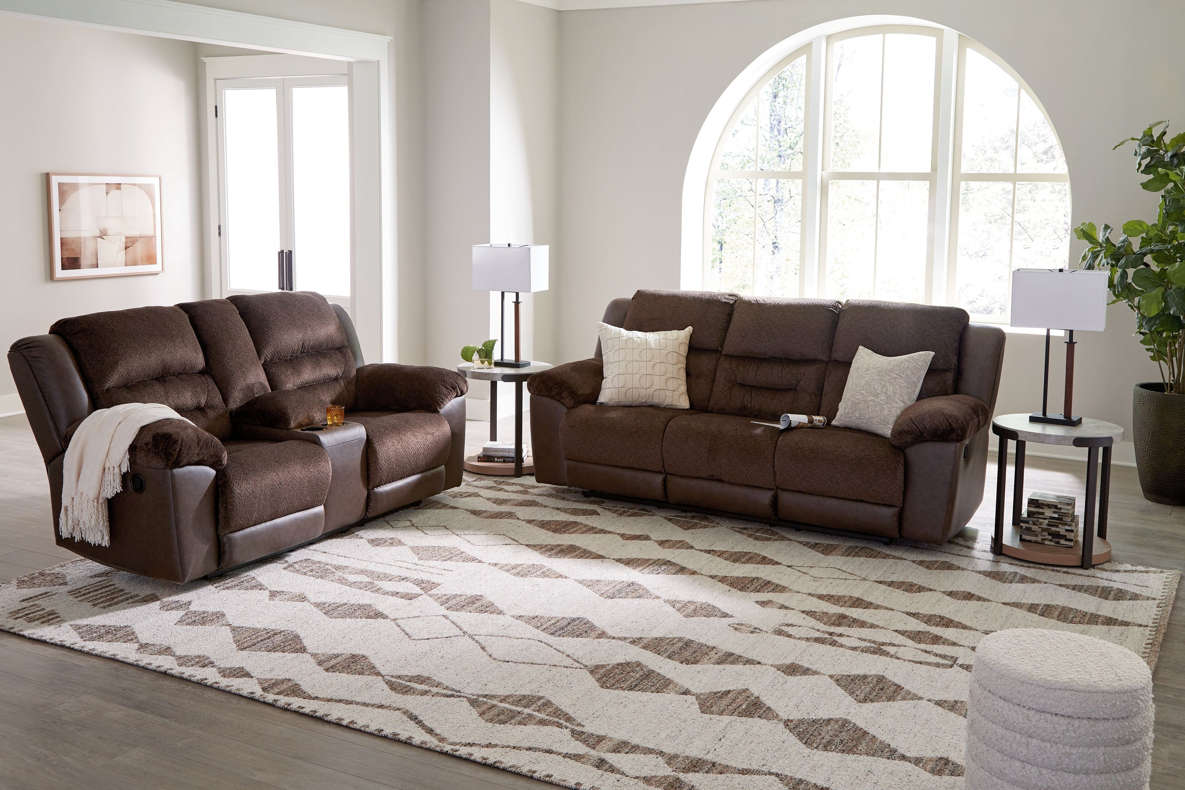 Geometric area rug with ivory base and dark brown diamond pattern in living room