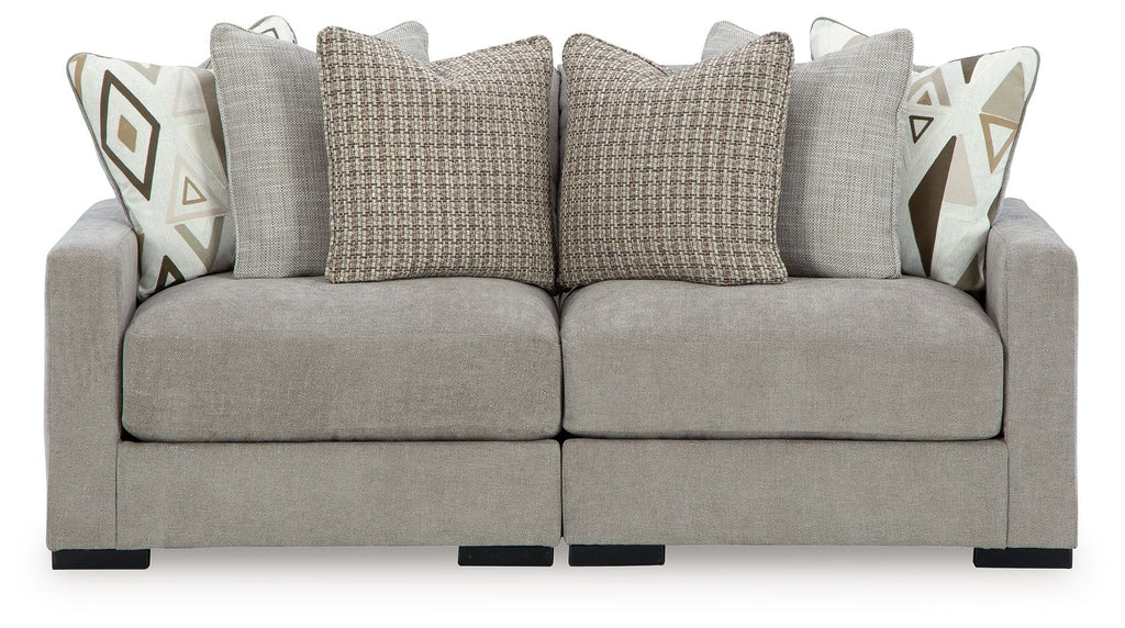 Pebble gray sectional sofa with back cushions and geometric accent pillows