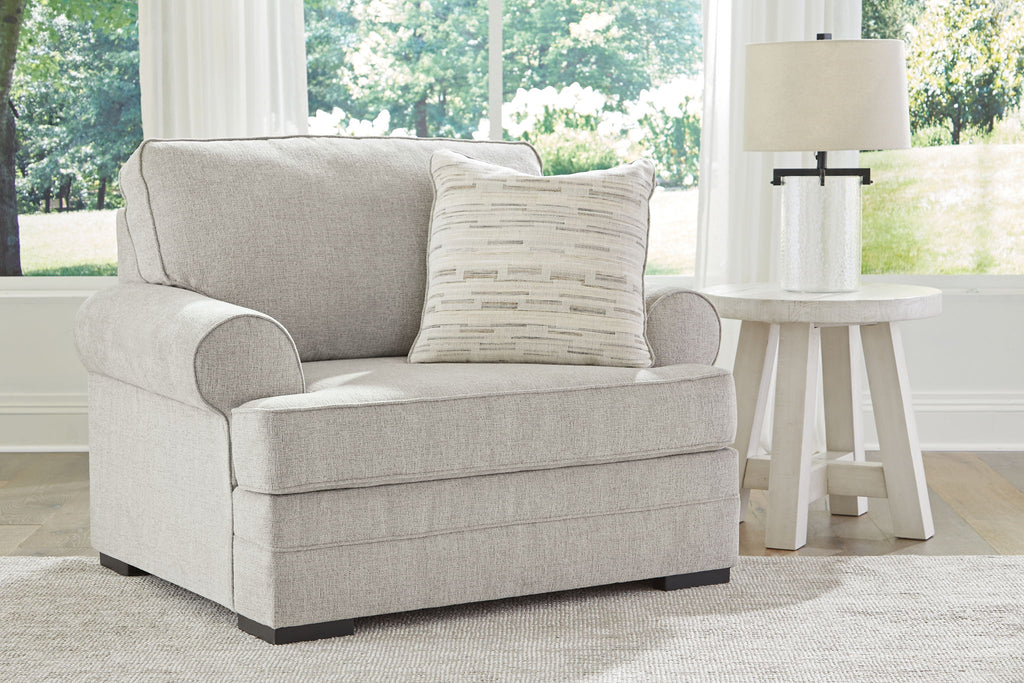 Gray upholstered armchair with lumbar pillow and coordinated throw cushions