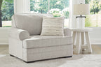 Gray upholstered armchair with lumbar pillow and coordinated throw cushions