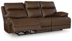 Brown power reclining sofa with padded arms, three seat cushions, and adjustable headrests