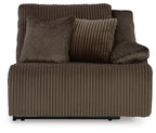 Chocolate-brown ribbed recliner chair with square throw pillows and thick armrests