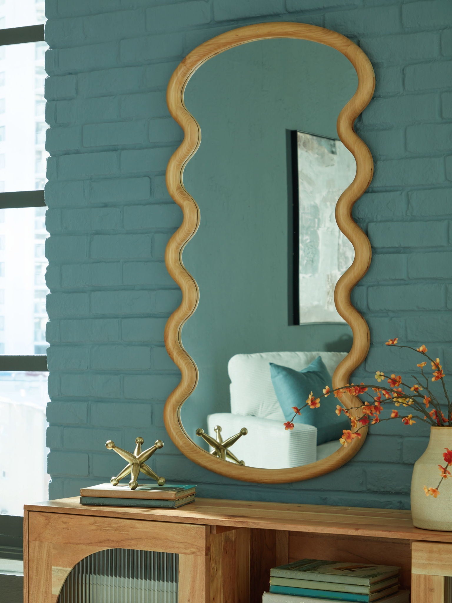 Framed brown wavy accent mirror with vertical reflective surface