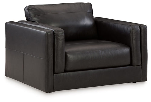 Amiata onyx chair and a half with dark leather upholstery and wide armrests.