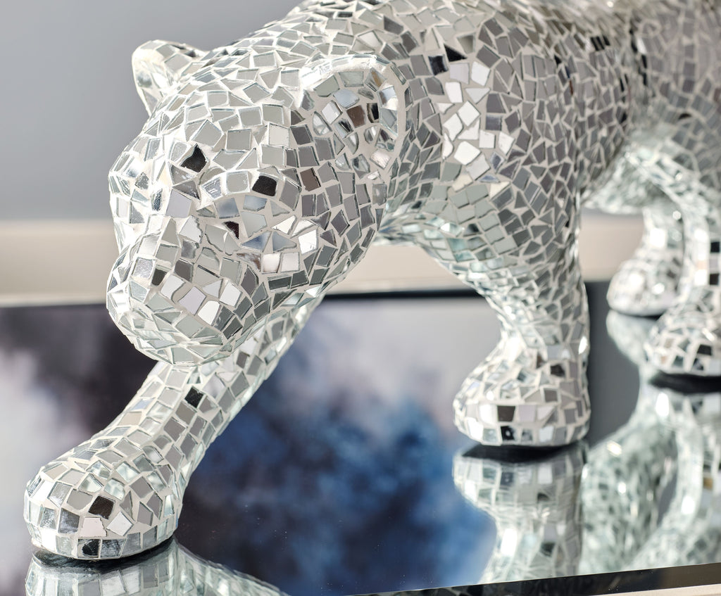 Silver-gray mosaic panther sculpture, head up and tail curved, standing on paws.