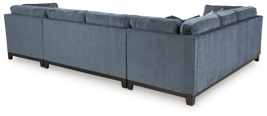 Blue sectional sofa with wide chaise and tufted cushions