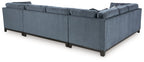 Blue sectional sofa with wide chaise and tufted cushions
