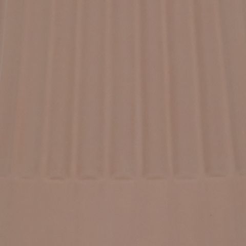 Mocha ceramic lamp base close-up with smooth curved rim and vertical ridges