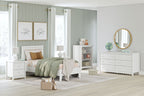 White bedroom set with platform bed, dresser with round mirror, and shelving unit