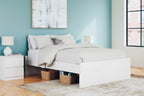 Platform bed with light wood frame and slatted base, styled with white bedding