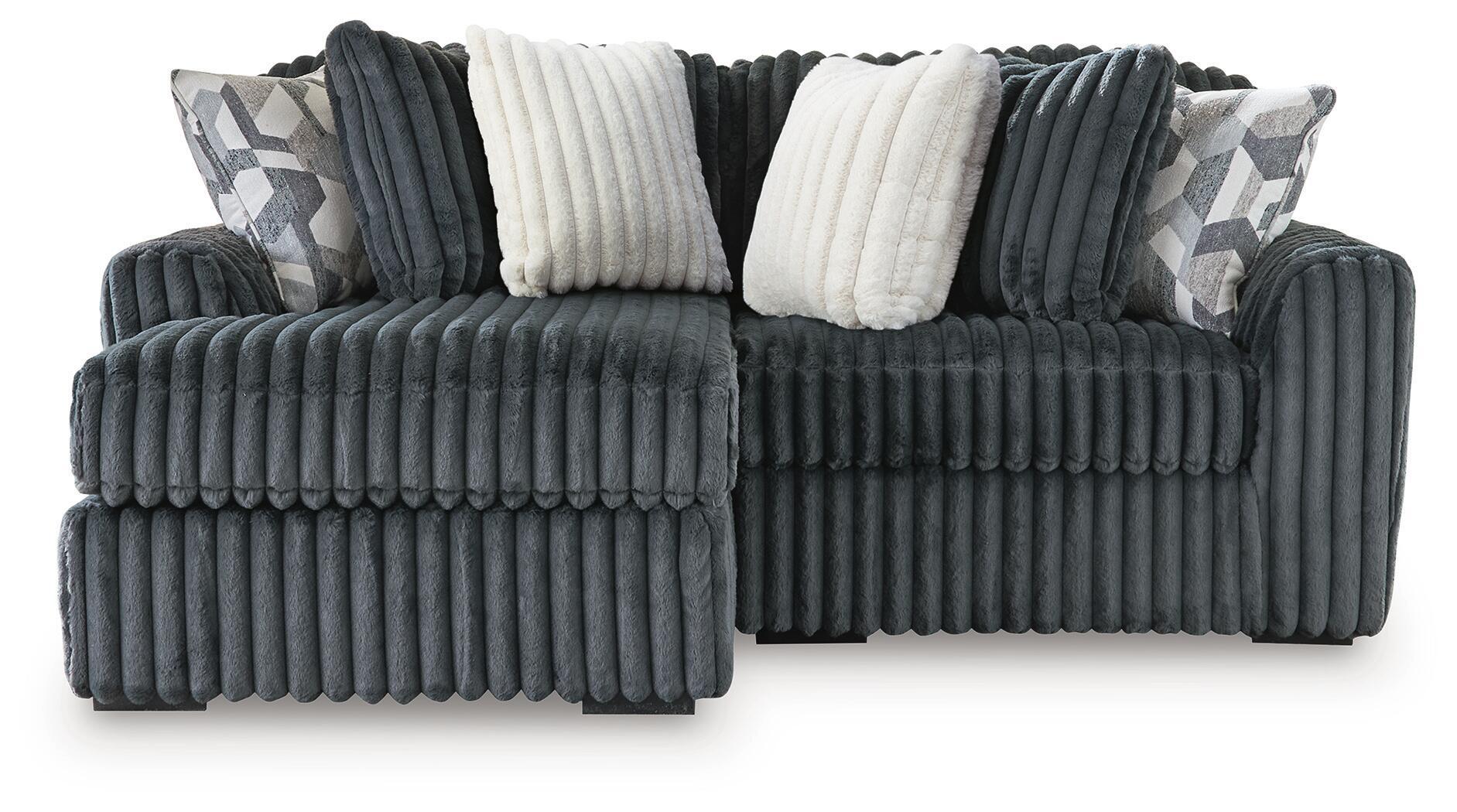 Charcoal corduroy sectional sofa with chaise seats and white accent pillows