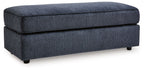 Oversized accent ottoman in cobalt blue with padded hinged top and tapered legs