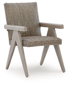Beige woven arm chair with light wood armrests and angled legs