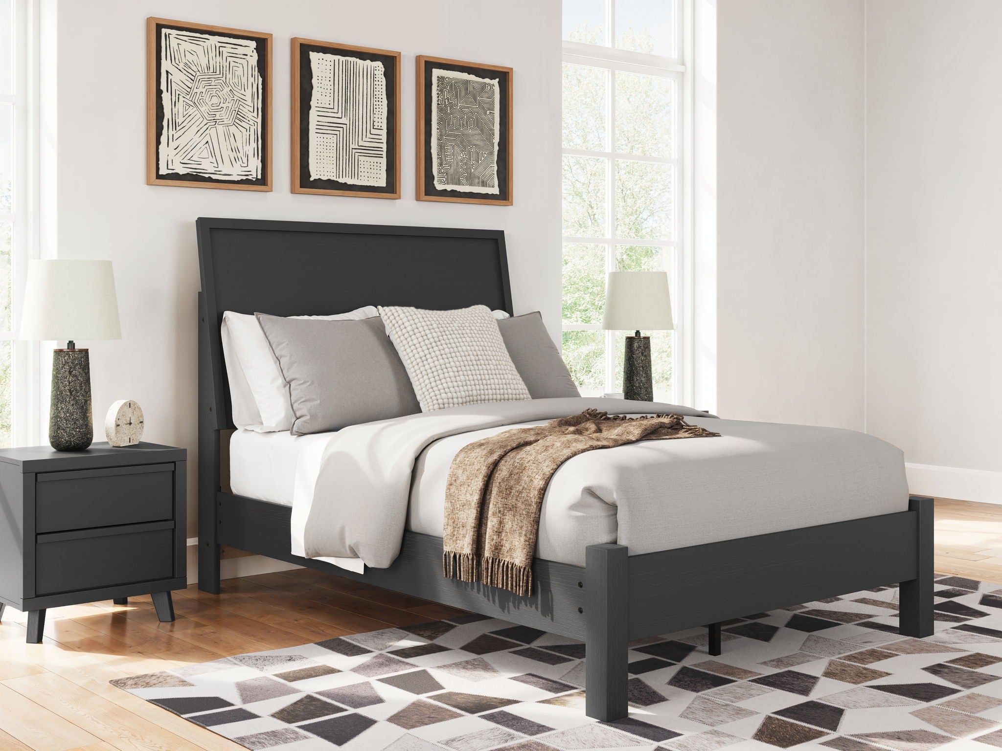 Black full panel bed with low footboard and headboard, white bedding with gray accents